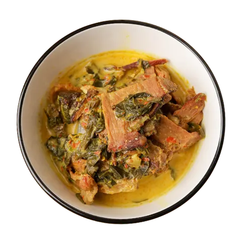Daging Salai Masak Lemak dalam mangkuk putih, kepingan daging salai dan sayur dalam kuah santan kuning